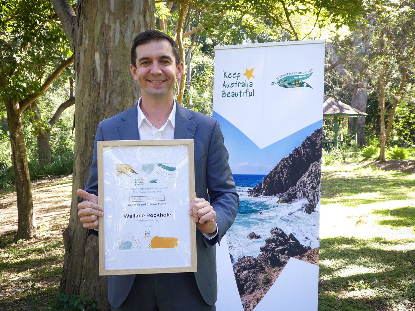 Hon Trevor Evans MP, Assistant Minister for Waste Reduction and Environmental Management with the 2021 Australian Sustainable Communities Tidy Towns Heritage and Culture Award presented to Wallace Rockhole, NT (joint winner) Heritage and Culture